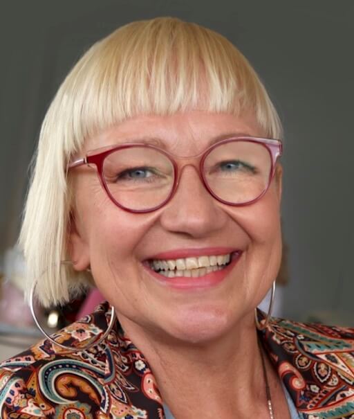 Anne Wiberg portrait blonde hair with red glasses smiling